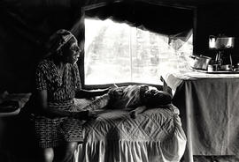 Black woman with her daughter in an emergency camp for homeless people in Inanda, Durban, Natal