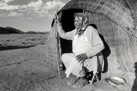 Tannie Hanna sits outside her reed house near Nourivier in the Leliefontein Reserve in Namaqualand