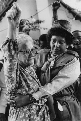 Mrs. Winnie Mandela hugs veteran anti-apartheid activist Mrs Helen Joseph at her 83rd birthday party