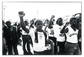 Raised fists and the coffin at the funeral of Msizi Dube in Lamontville