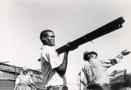 Mogopa people building their temporary houses in Onderstepoort after their forced resettlement to...