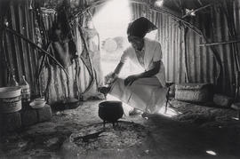 Mrs. New preparing food at home in Namaqualand, a rural area for coloured people in the Northern ...