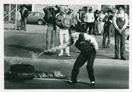 Setting fire to a barricade in Mitchell's Plain.