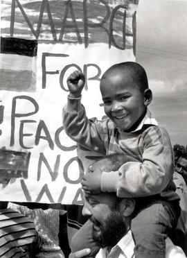 Young boy and his father at a 'March for Peace' through the small rural town of Oudshoorn