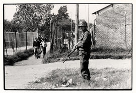A soldier stands guard outside a school in Soweto