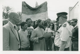 Isaac Josephs handing a list of demands to the police after a march in Oudtshoorn