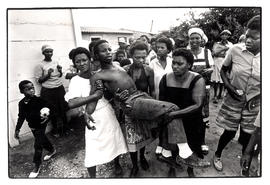 16 year old Thabong boy is carried by women after he was shot by 'Blacks Jacks' (municipal police)