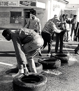 Pupils of Western Cape township schools set up a tyre barricade as part of their protest against ...